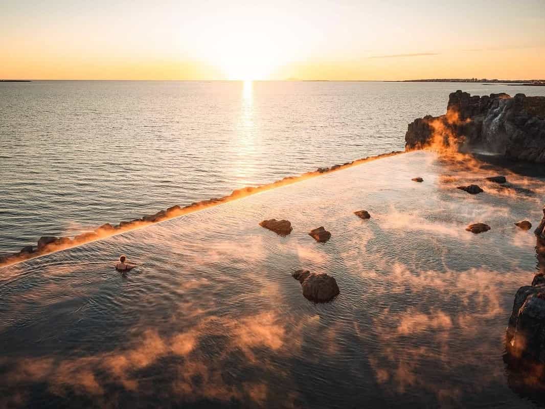 Woman looking towards the ocean from the infinity pool at the Sky Lagoon, Iceland. Photo: Tripadvisor