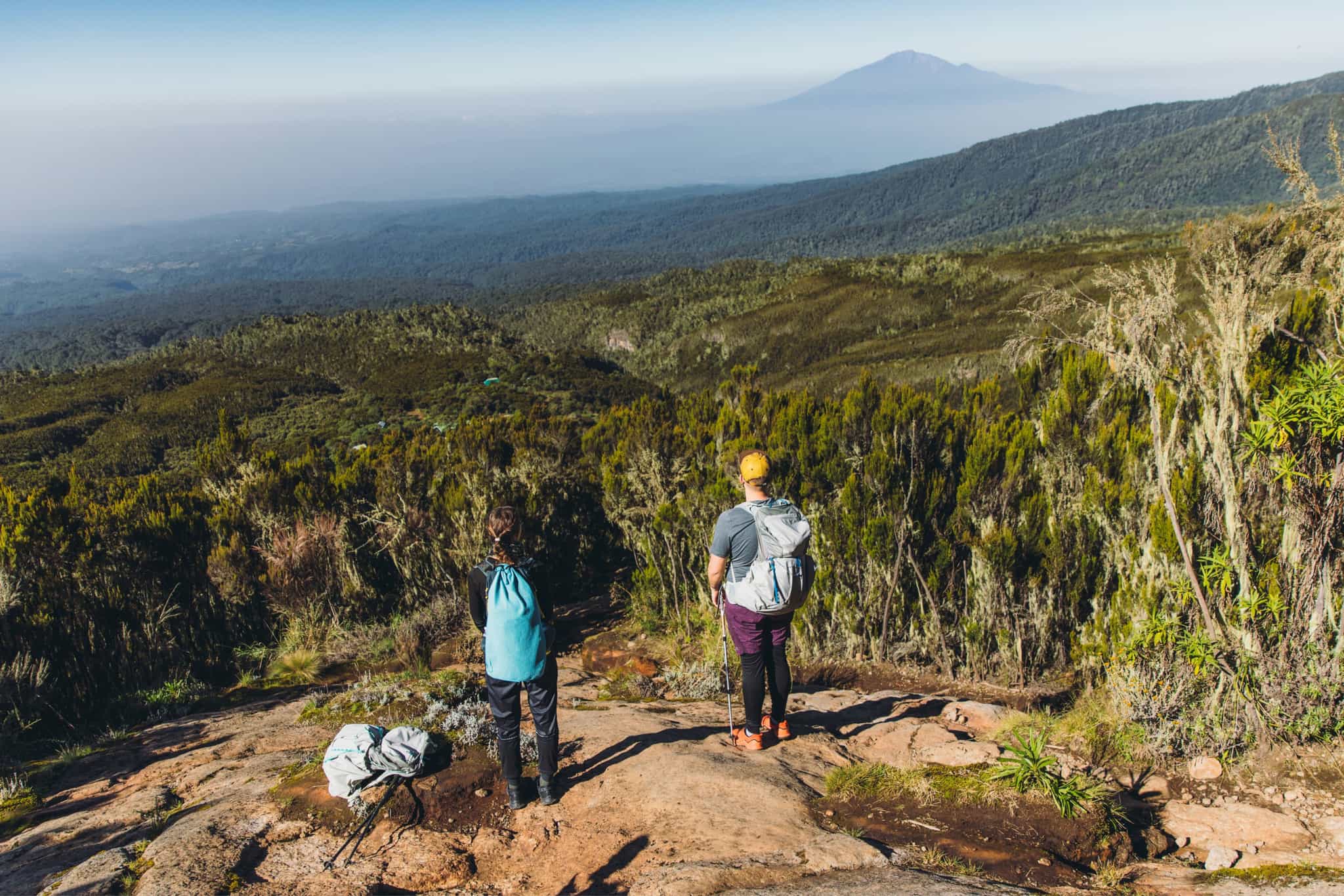Hikers with view of Mt. Meru, overlooking Kilimanjaro forests. Photo: GettyImages-1306860671