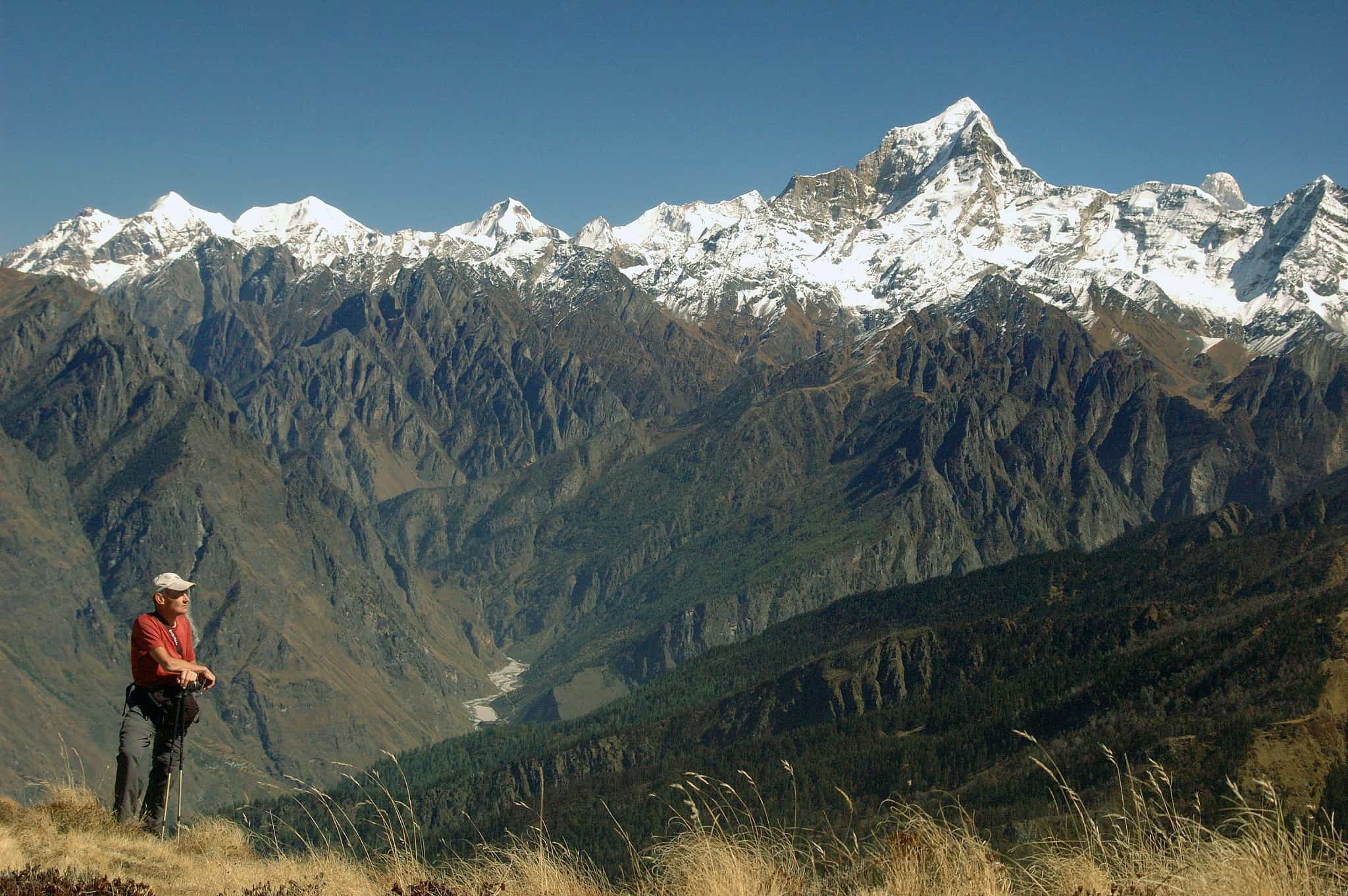 Hiker overlooking a Gharwal Panorama, India