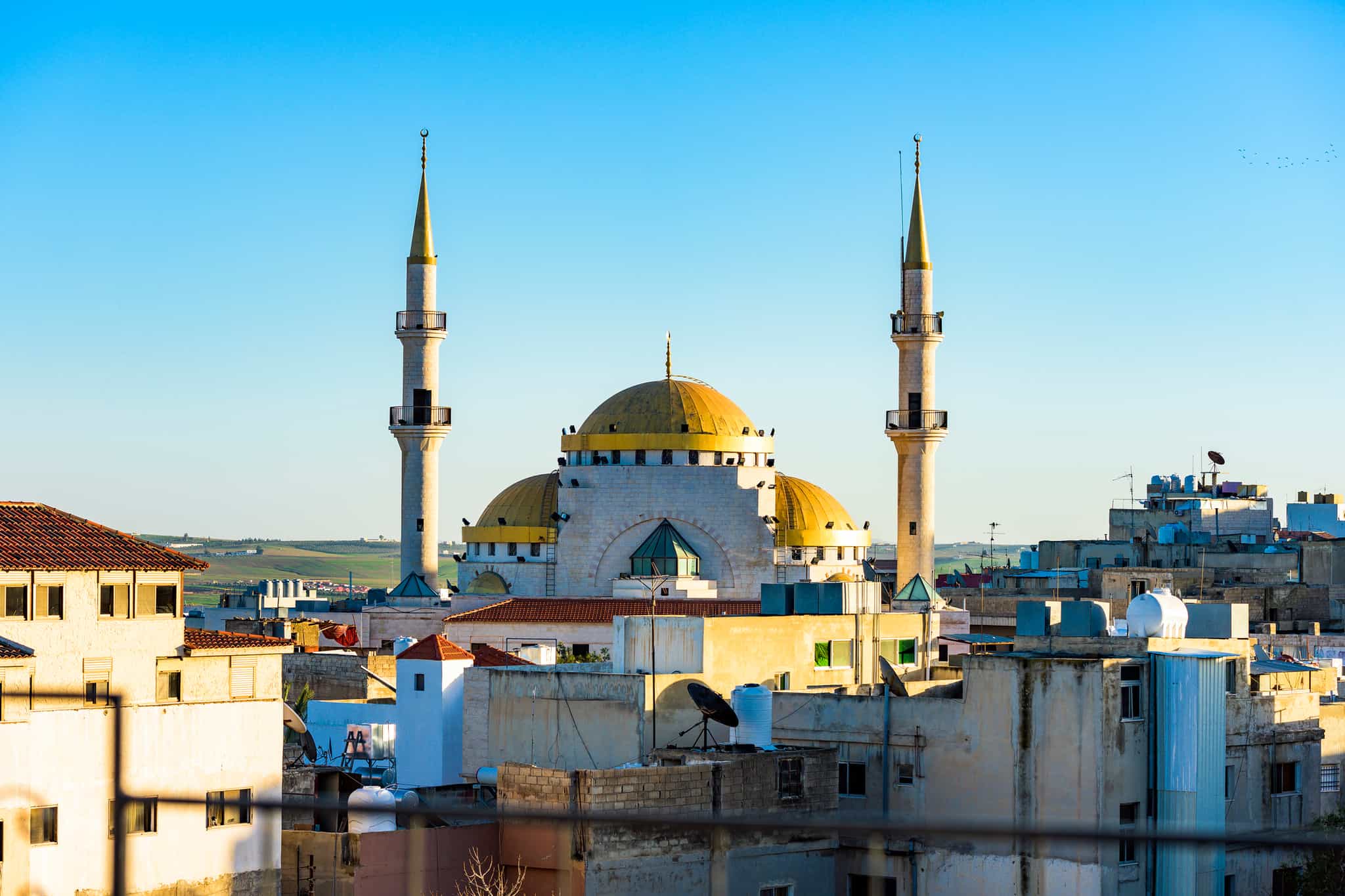 View of the Mosque of Jesus Christ illuminated at sunset in Madaba, Jordan