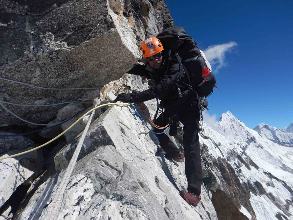 Host Jagen up Mardi Peak, with ropes. Photo: Jagen