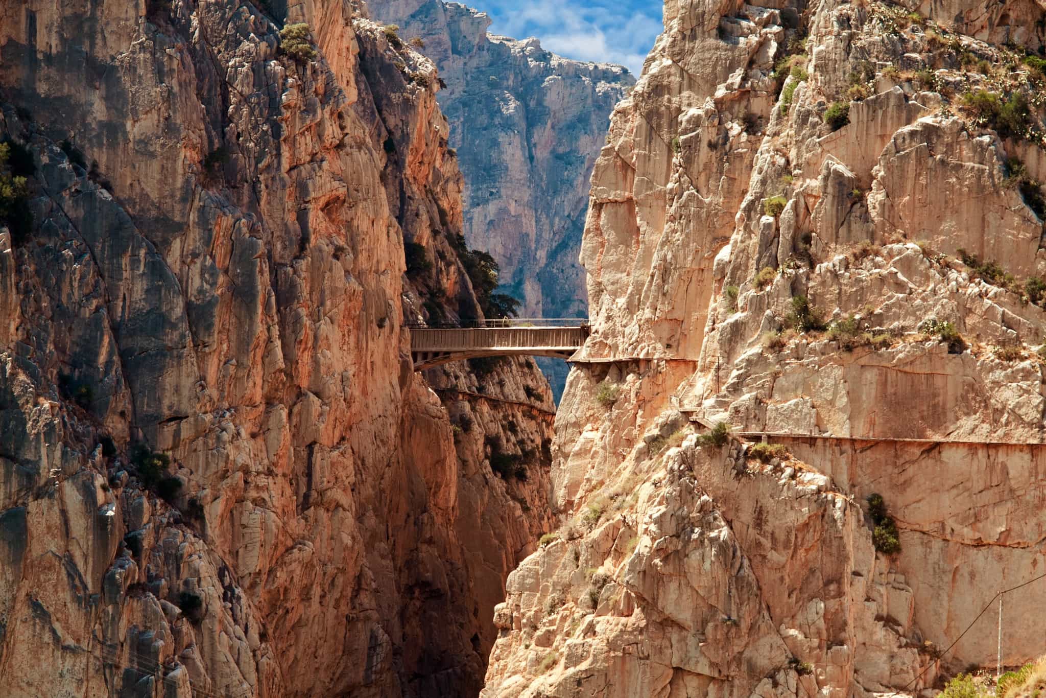 Hikers on a bridge on the Chorro gorge hiking the Caminito del Rey, Andalucia, Spain.