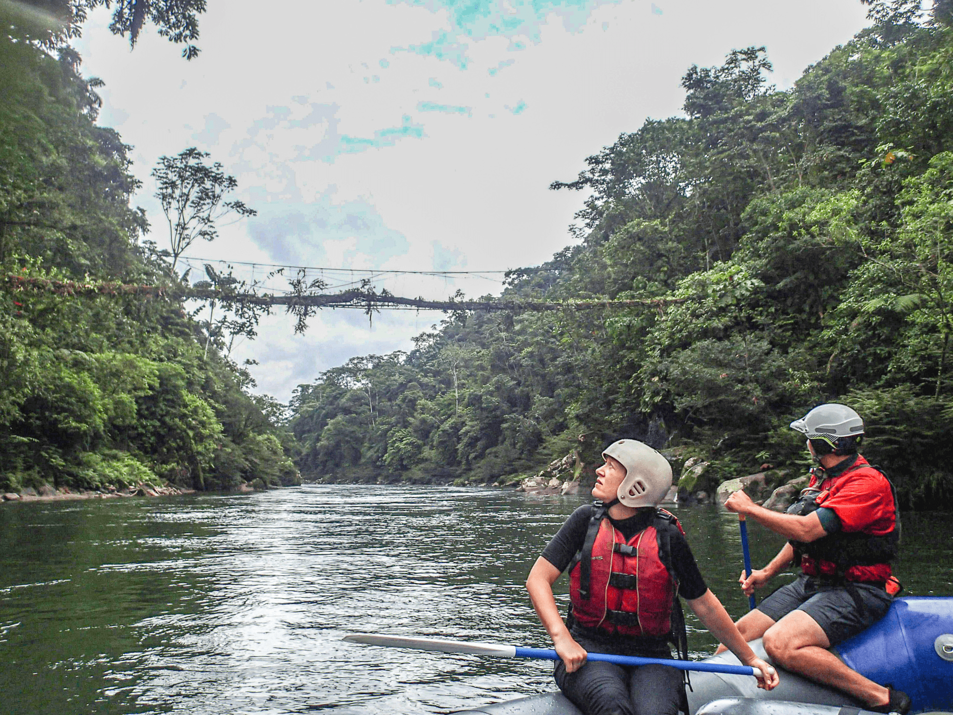 Two people raft the Jatun Yacu River in Ecuador's Amazon Basin.