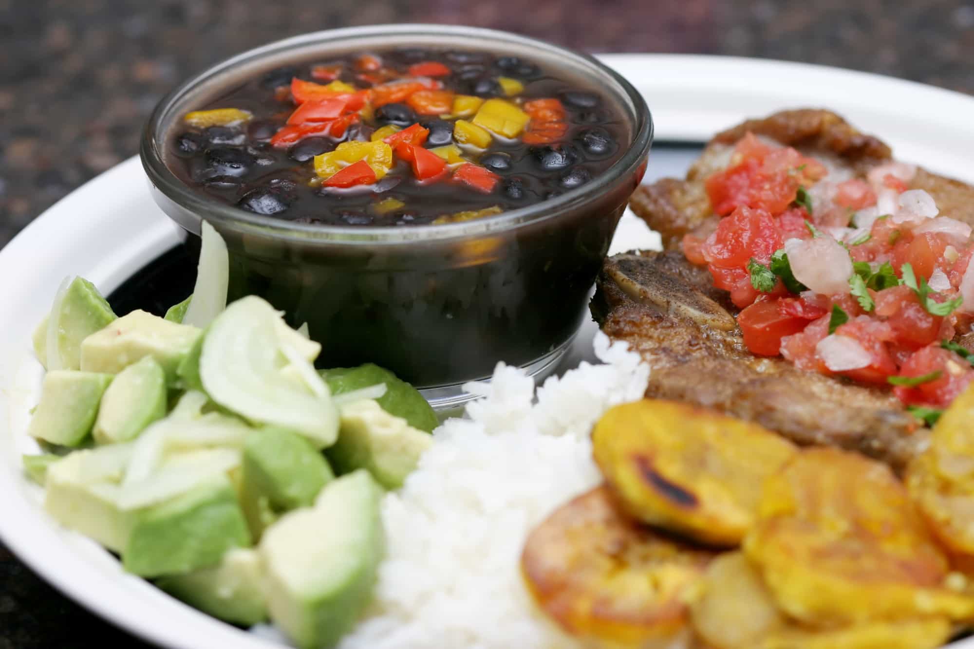 Cuban dinner consisting of rice, beans, plantains, and beef steak. Photo: GettyImages-139864055