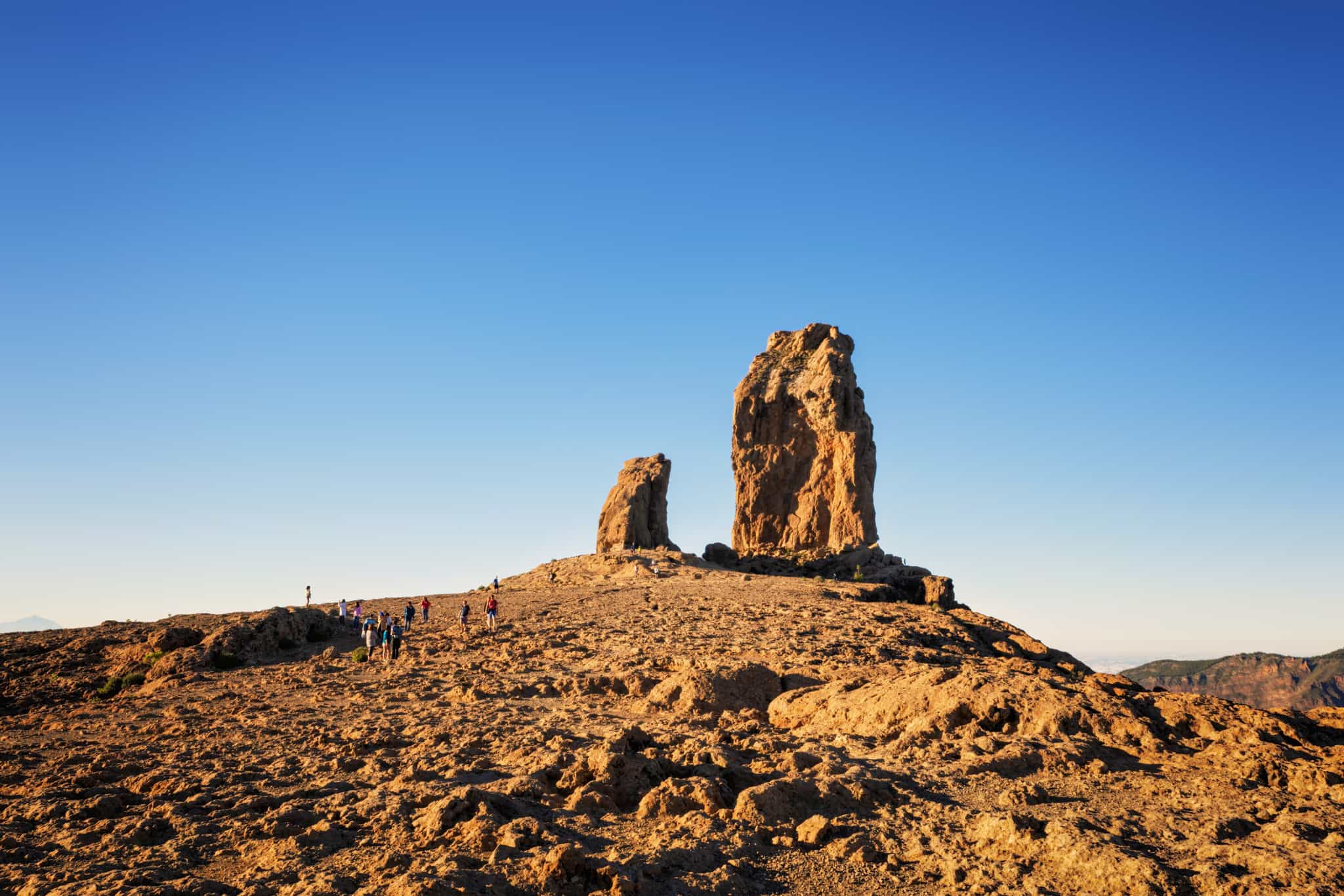 People walking towards the rock formation of Roque Nublo in Gran Canaria.
