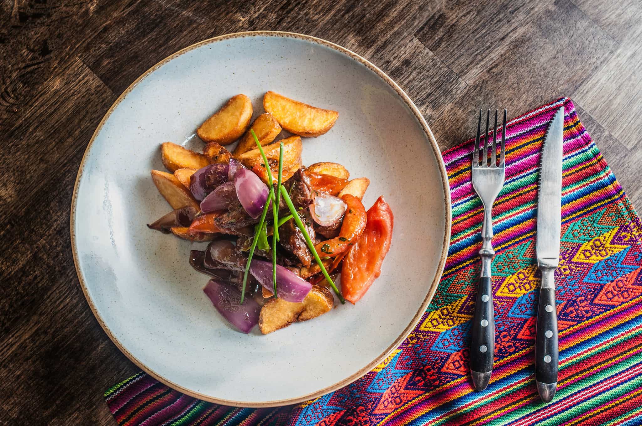 A plate of Lomo Saltado, a traditional beef and potato dish in Peru.