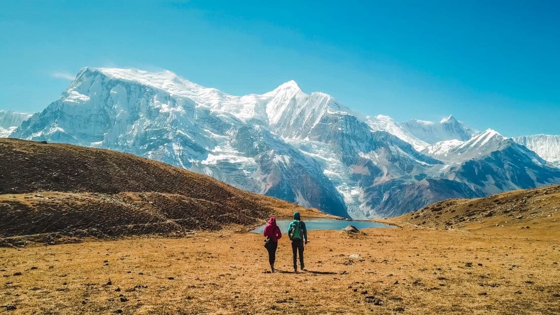 Two hikers walking in the Annapurna range, Nepal.
