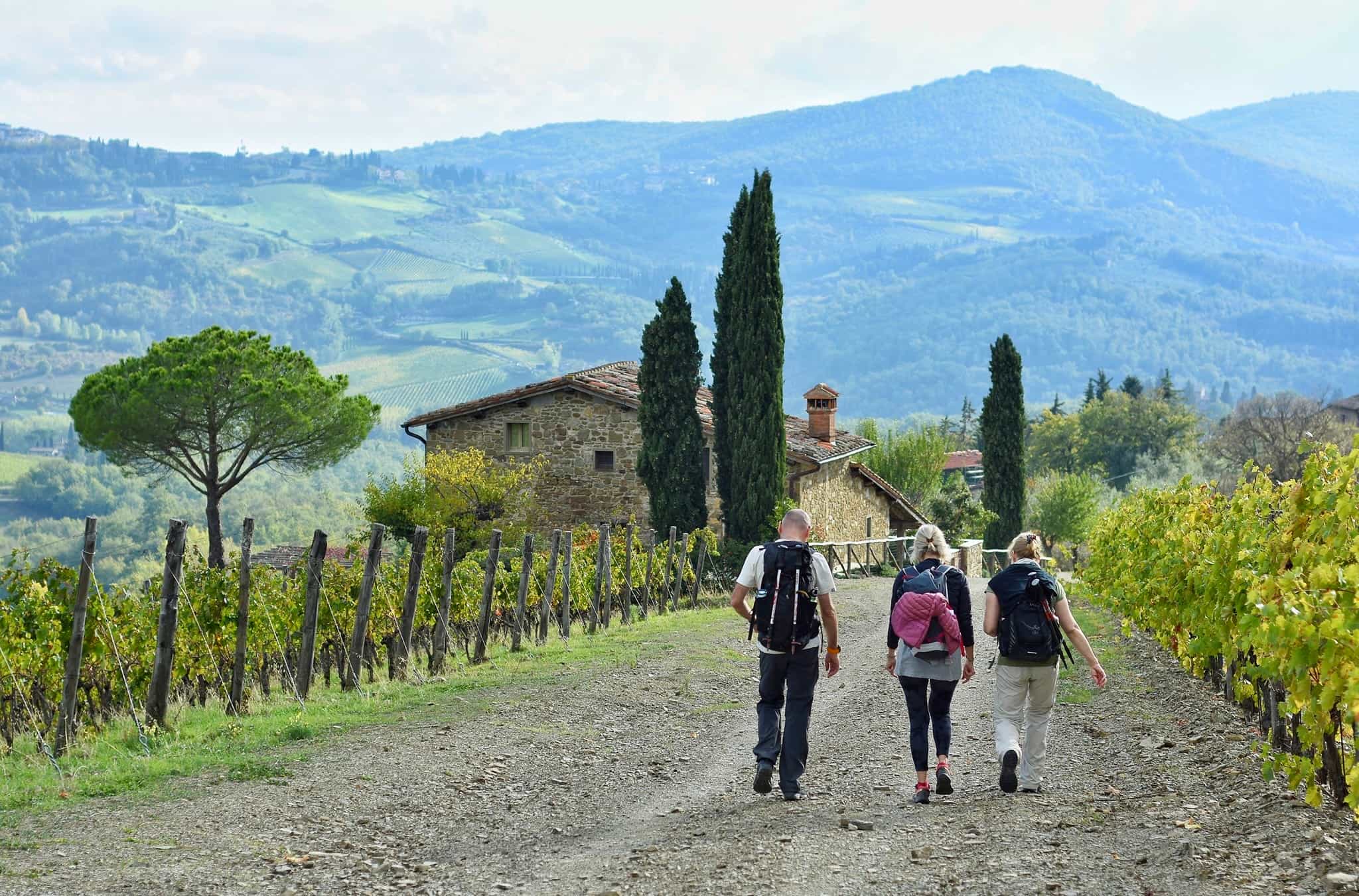 Three hikers on a trail in in Tuscany's Val d'Orcia.