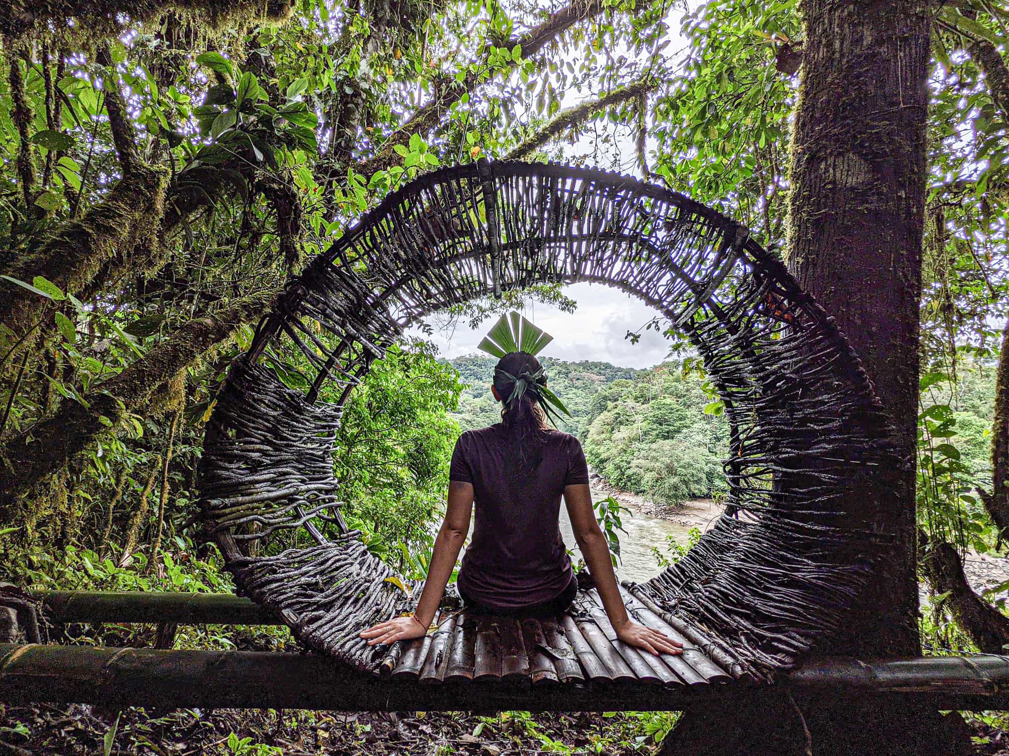 A woman relaxes on a bench at the Kuyana Lodge in the Amazon Rainforest, Ecuador.