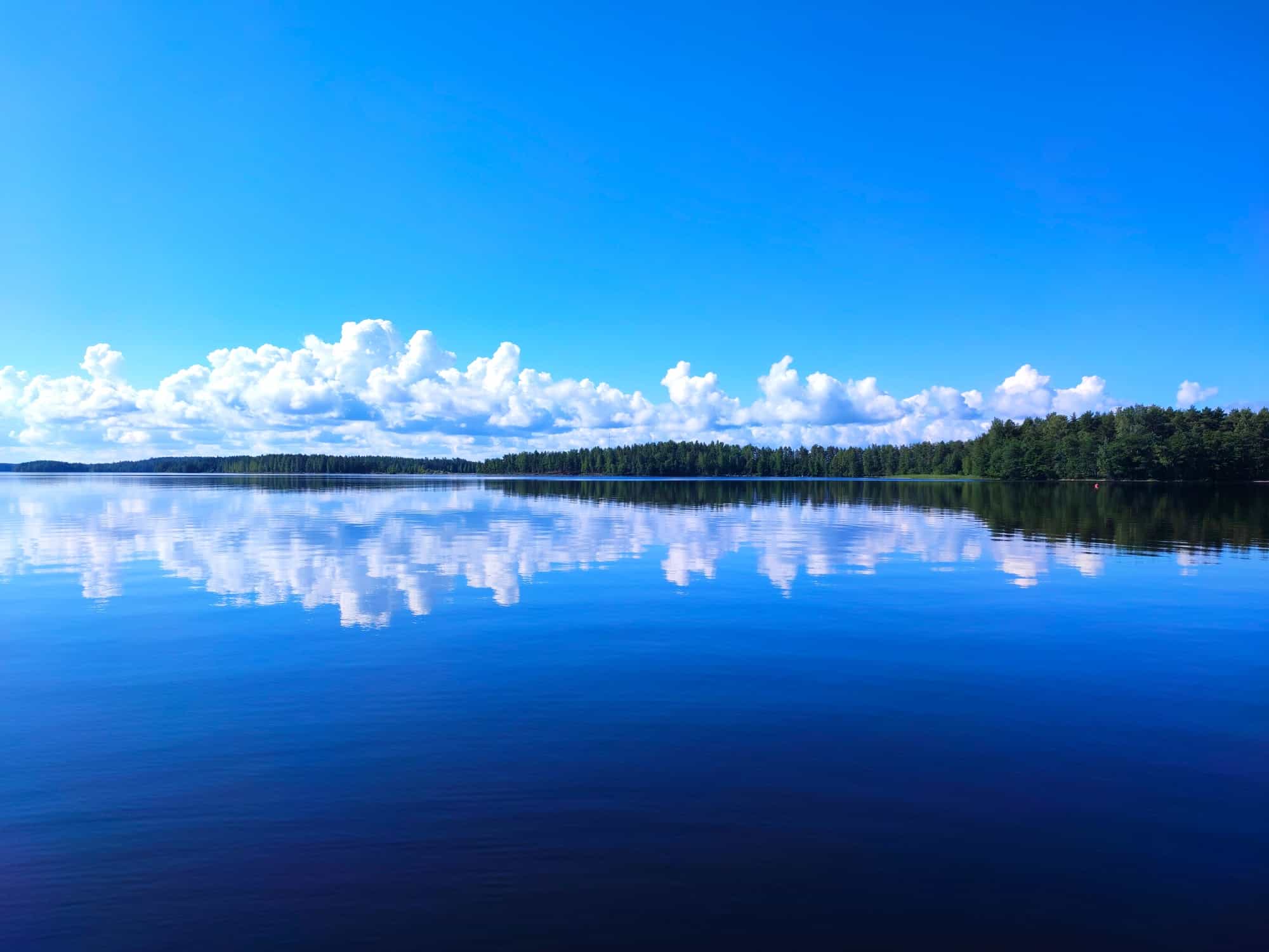 Lake mirroring the blue sky, Lake Saimaa, Finland