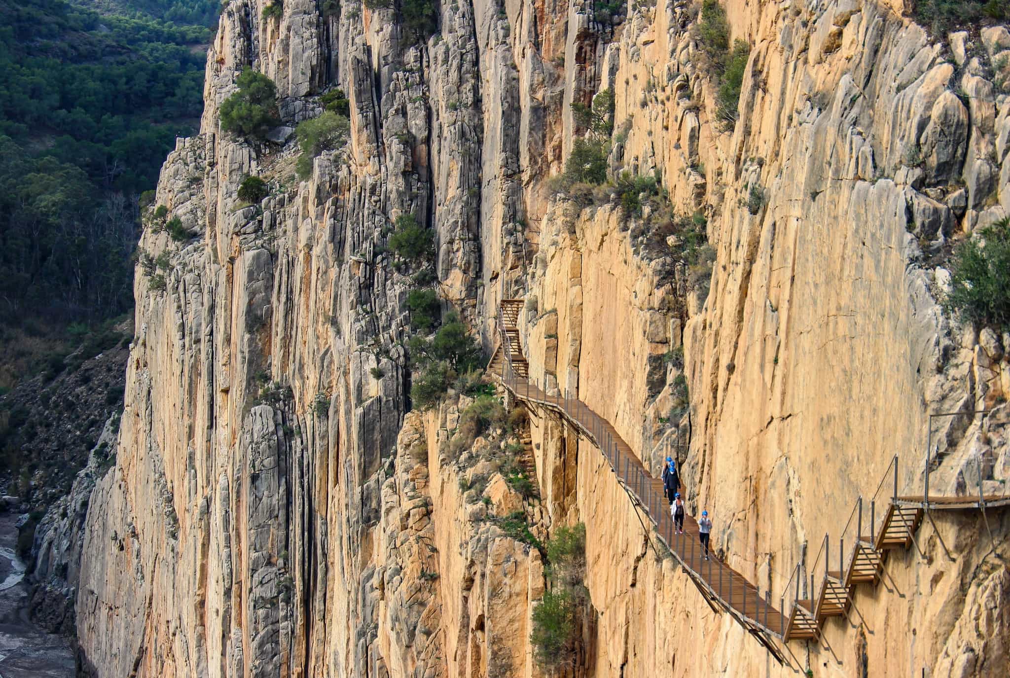 Hikers on a vertigo-inducing section of the Caminito del Rey, Andalucia, Spain.