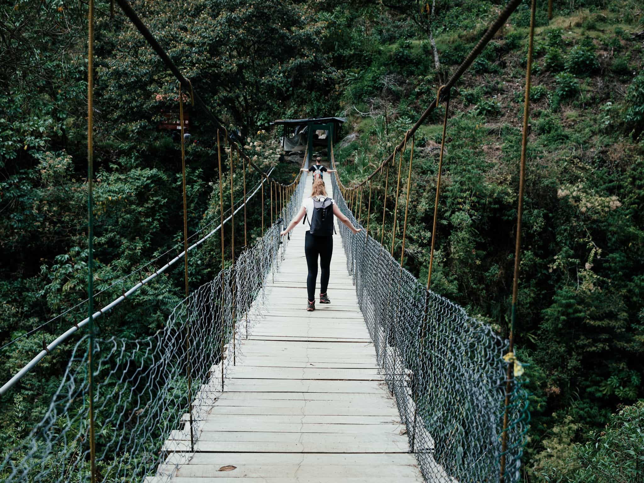 Hikers crossing a bridge on the way to Aguas Calientes via Llactapata in Peru.
