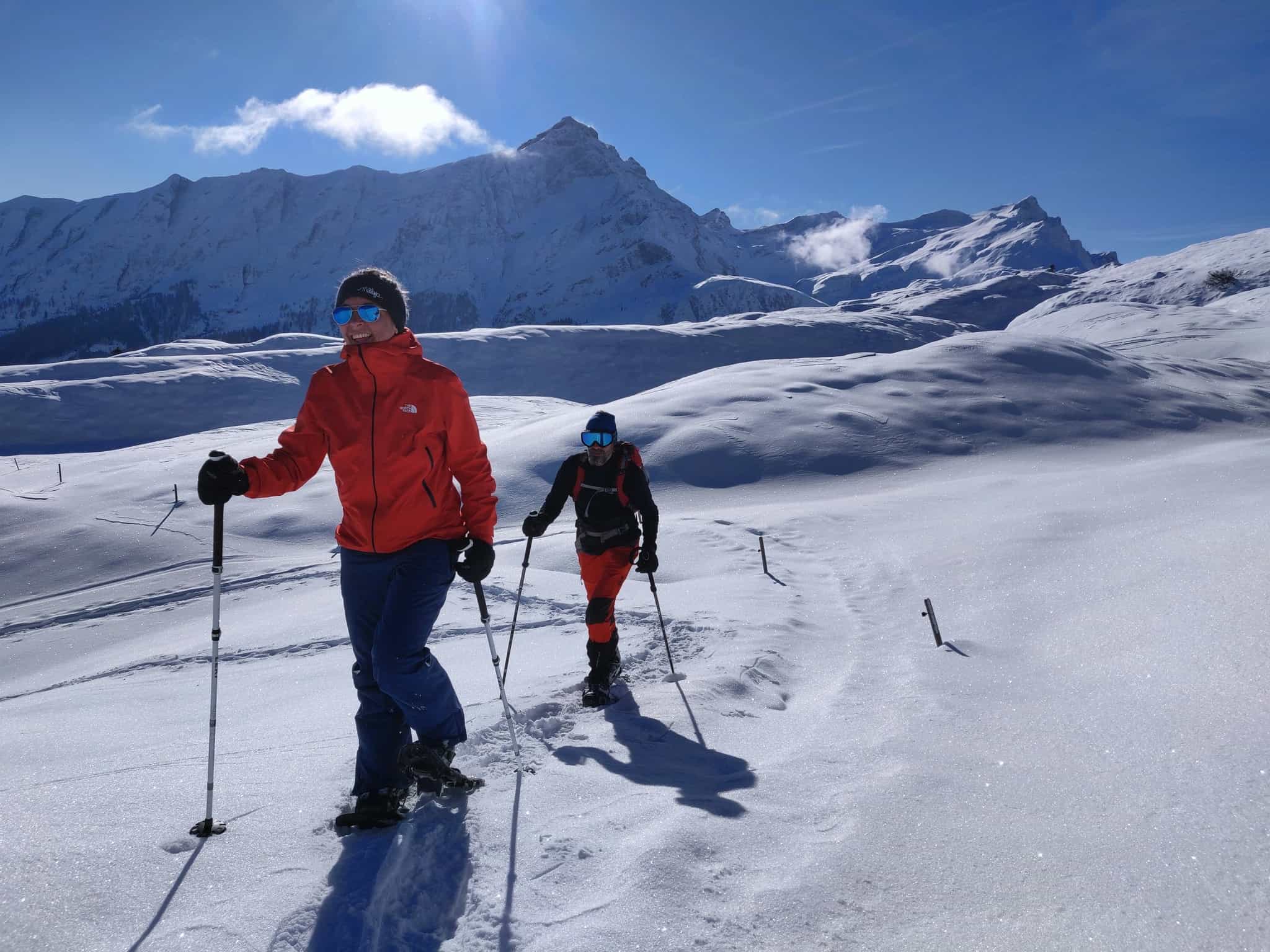 Smiling hikers snowshoeing in the Dolomites, Italy.