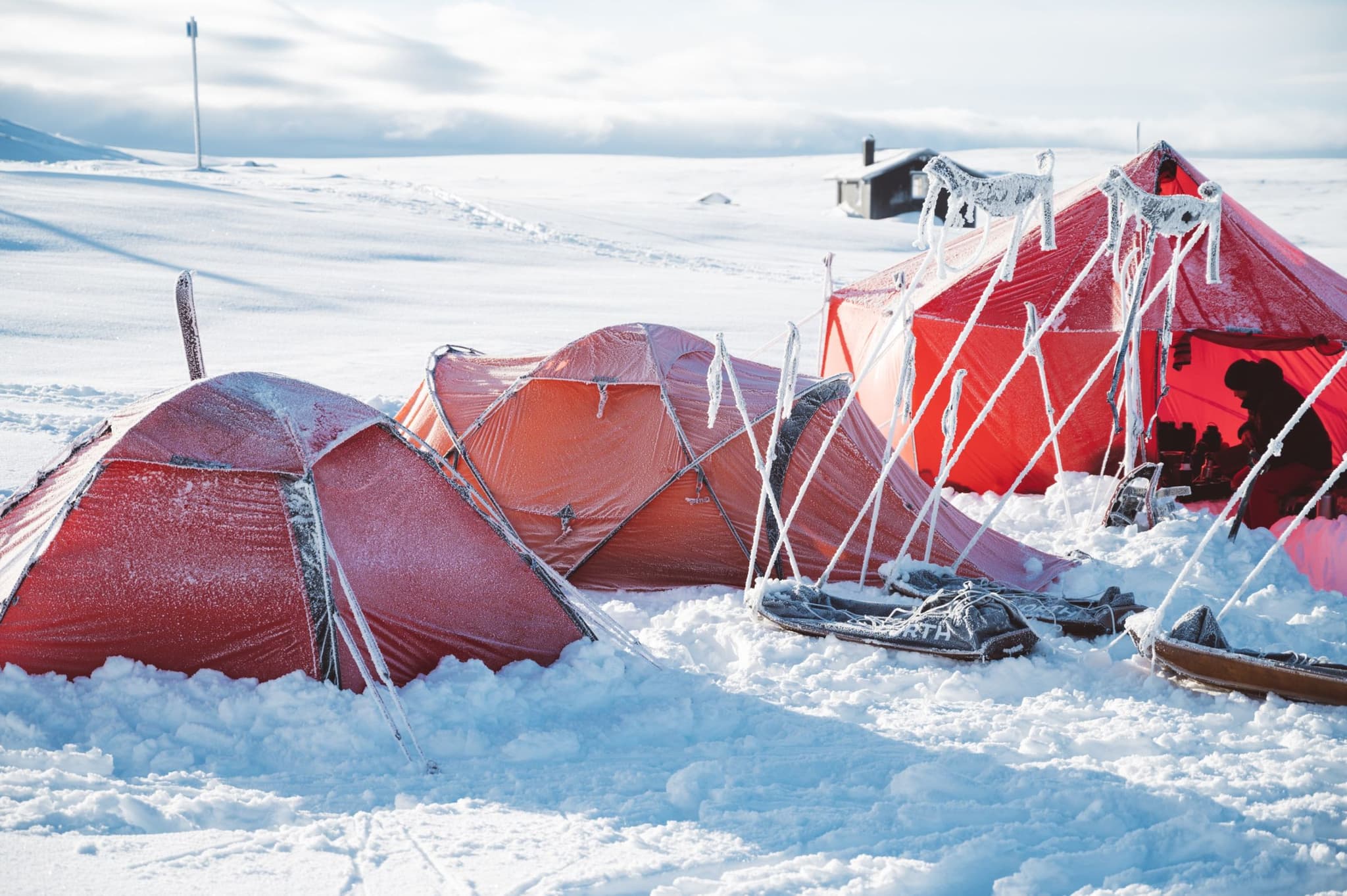 Tents, covered with ice, in the winter snow.