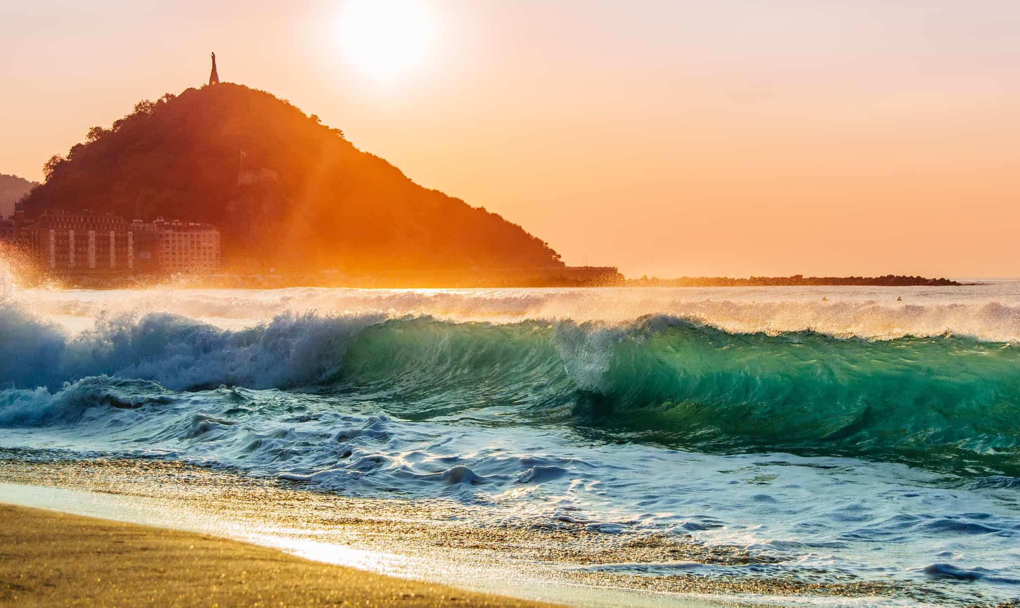 A nice shorebreak during sunset at the Zurriola beach of San Sebastian.