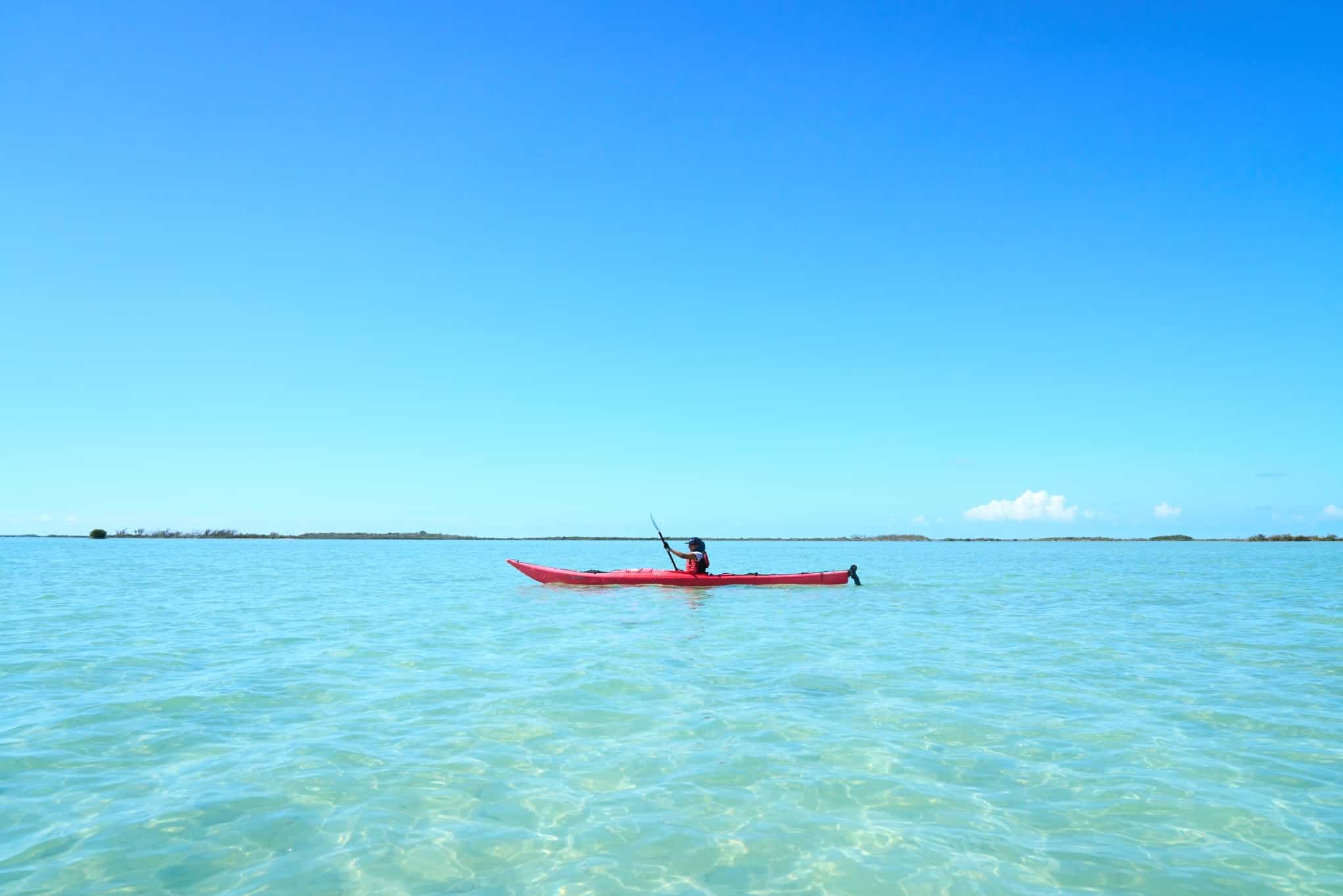 Person kayaking on bright clear water in Cuba, Photo: Commissioned/Daniel Wildey