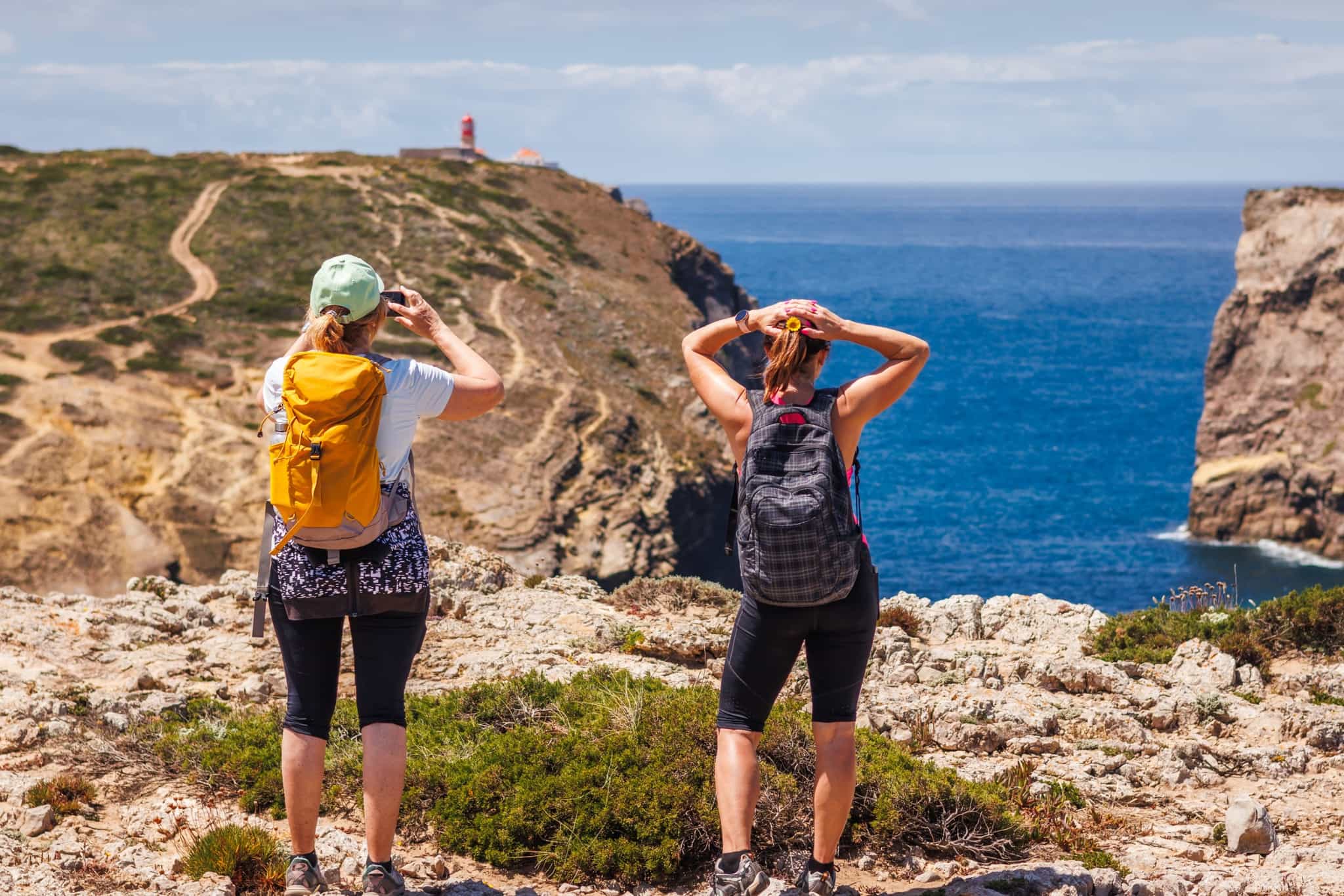 Hikers approaching Cabo de São Vicente, Sagres, Portugal. Photo: shutterstock_2480059845