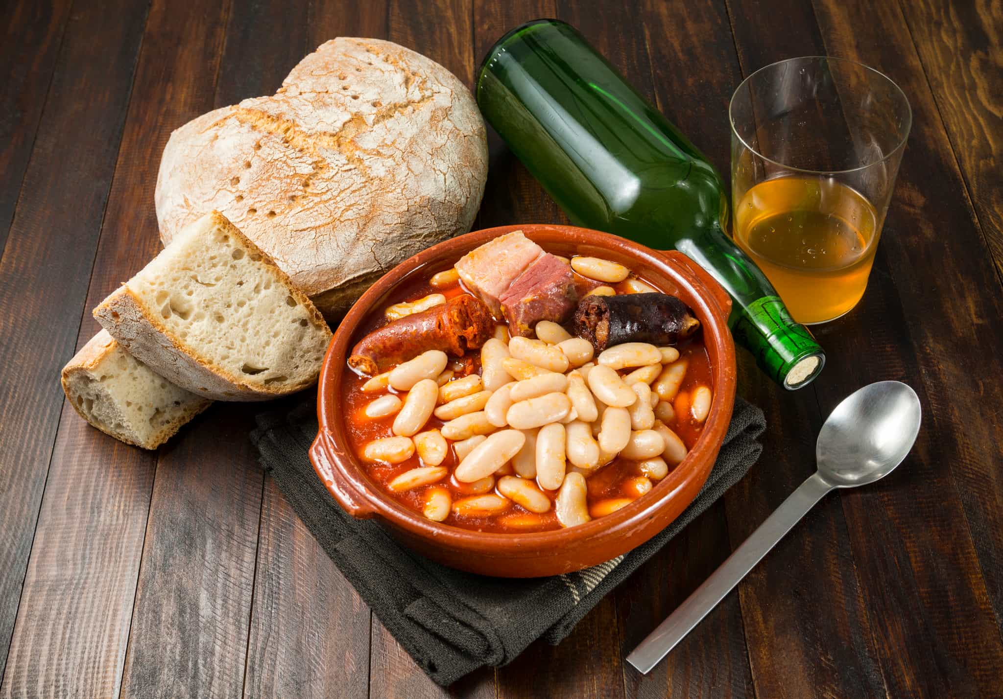 A dish of fabada bean stew with cider, an traditional meal of northern Spain.