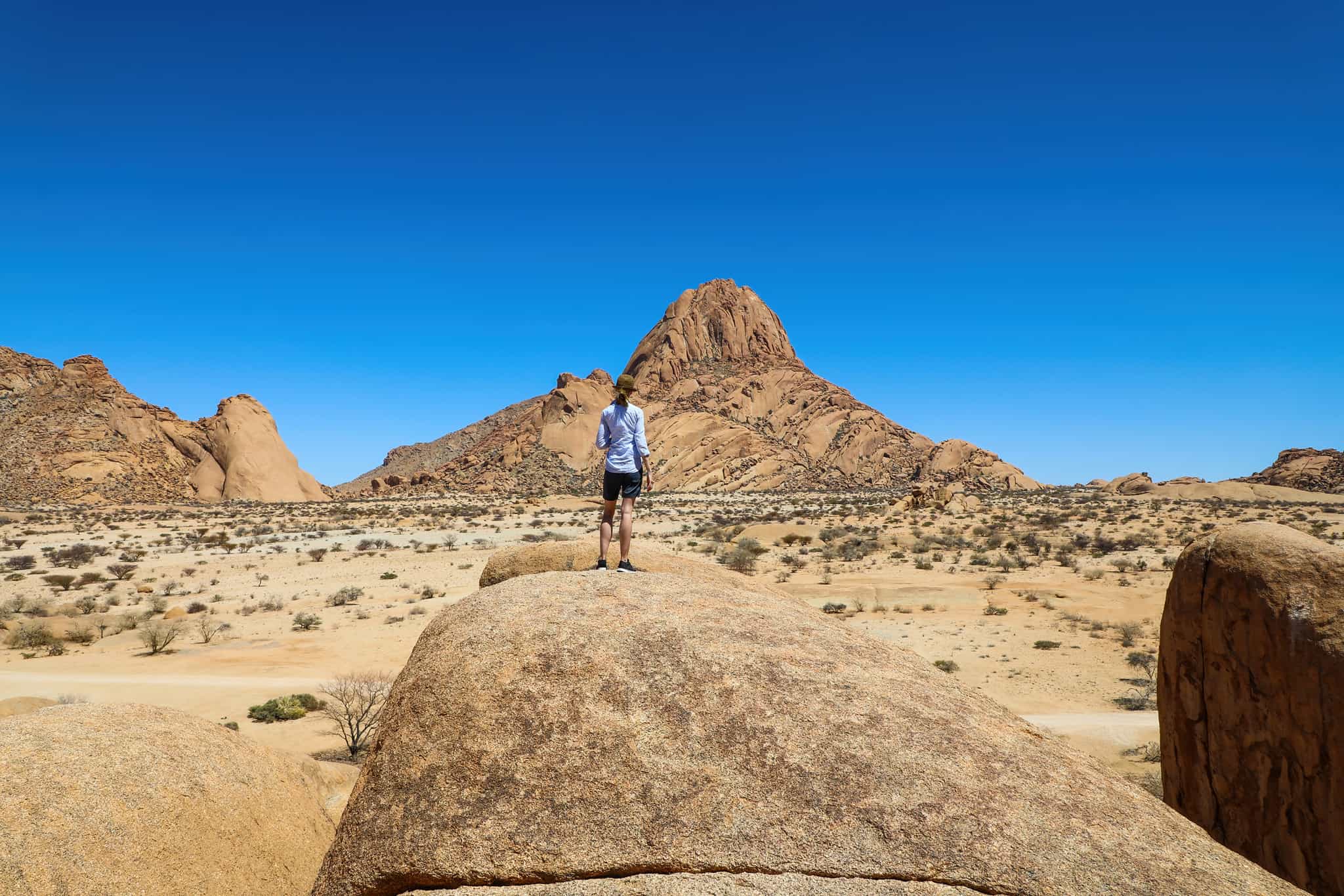 Hiker looking out over a view of Spitzkoppe Mountain