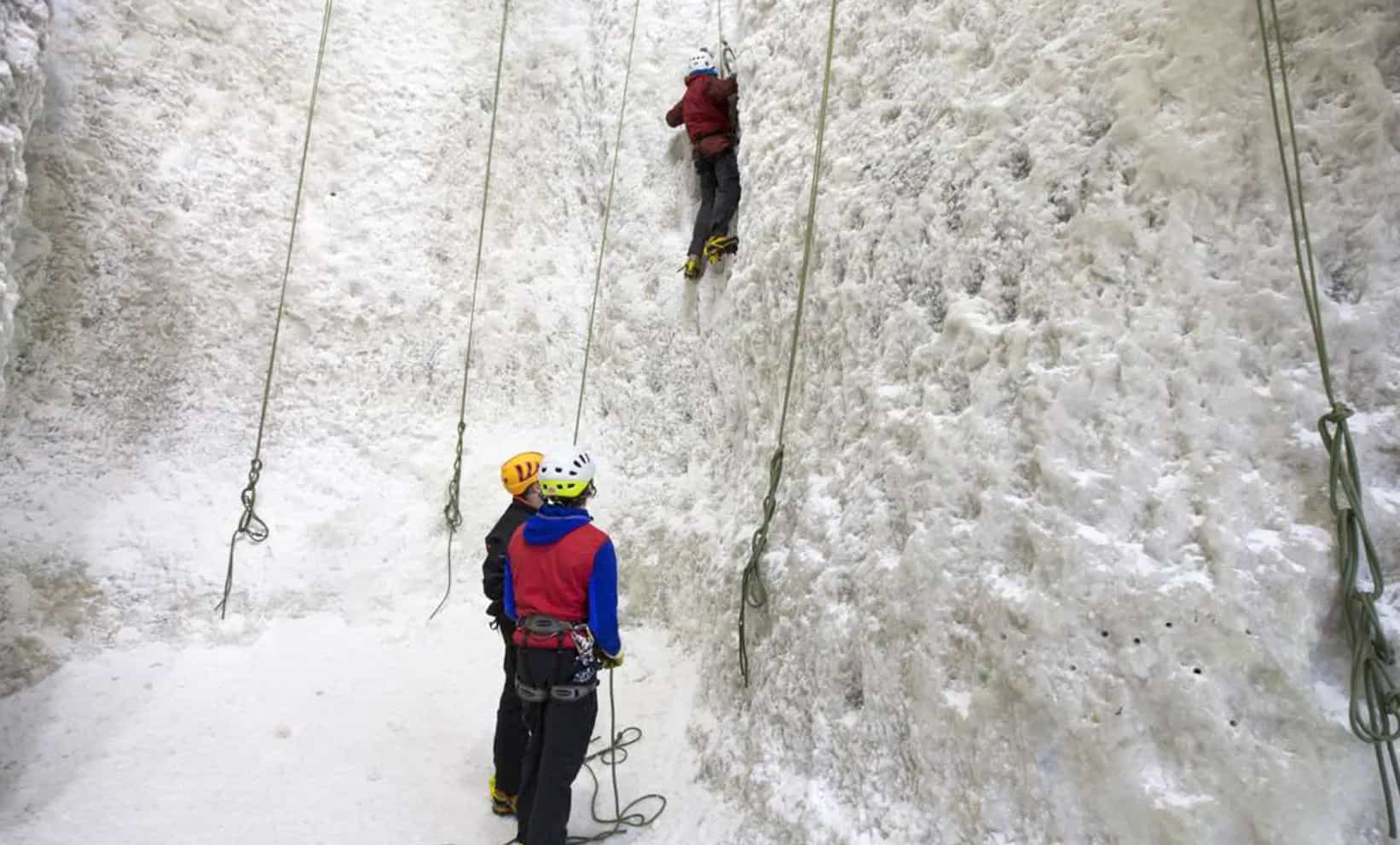 3 people ice climbing in Scotland